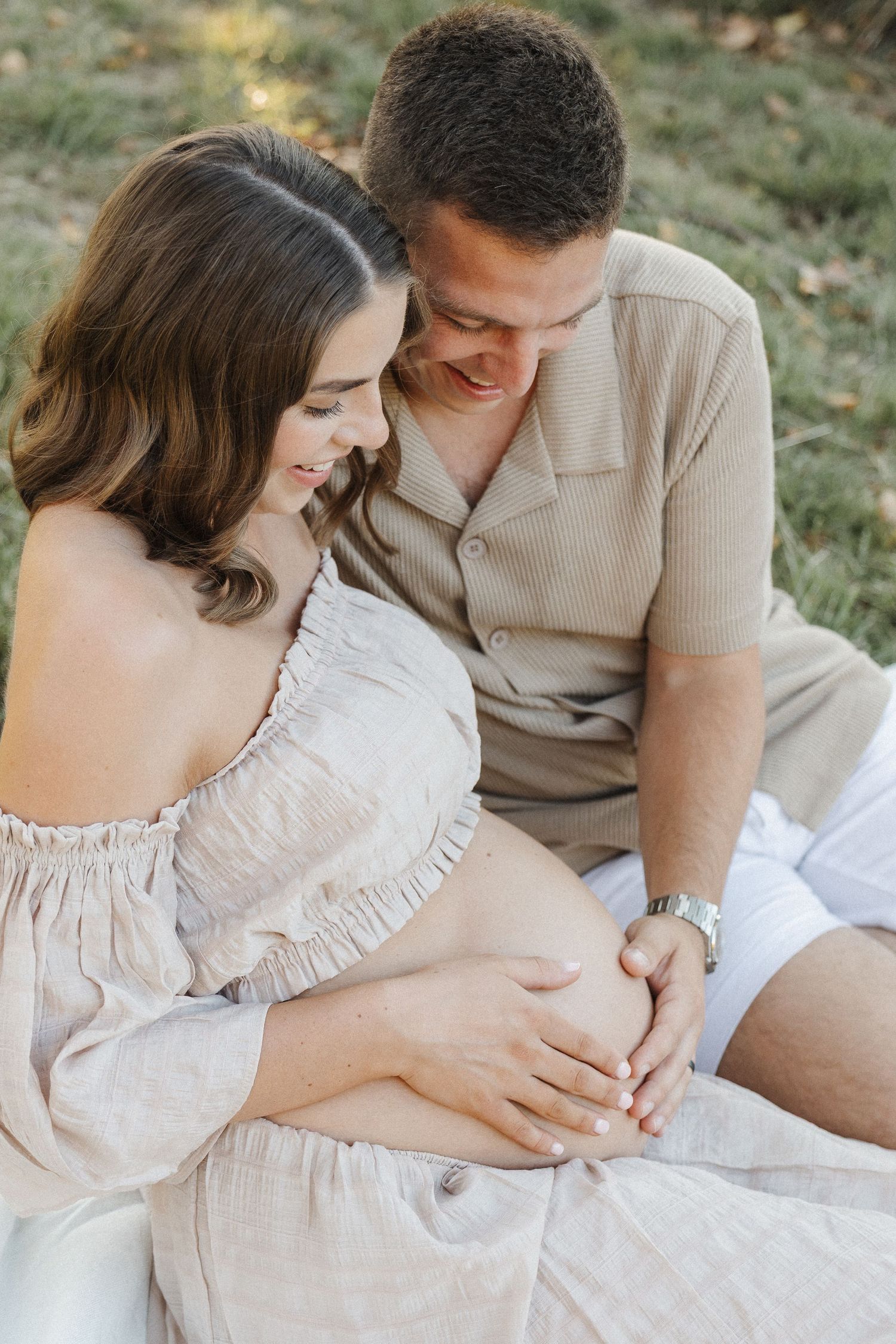 maternity photographer in Canberra capturing mother and father holding pregnant belly