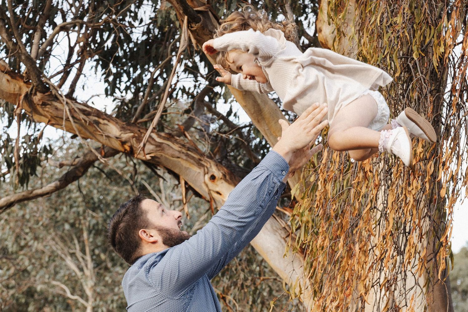 Flying little girl with her father in Canberra family photoshoot