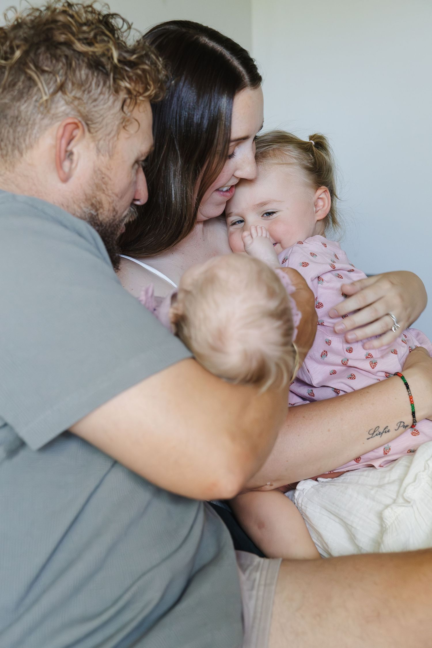 Toddler laughs in newborn photoshoot Canberra