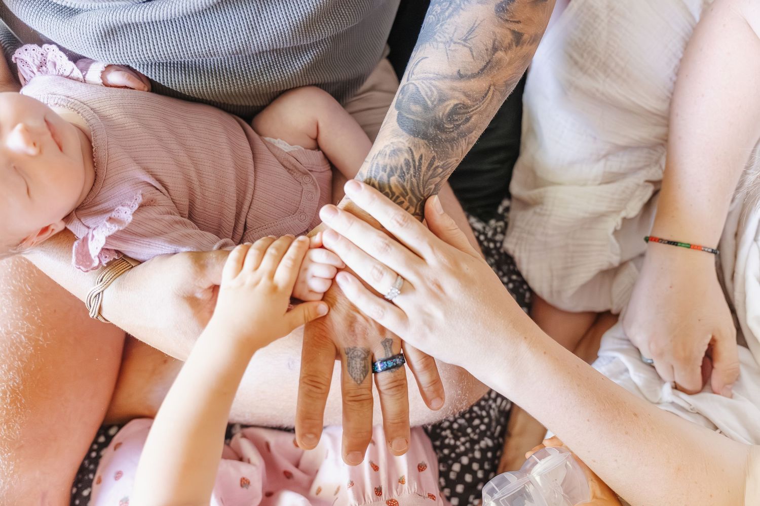 The whole family's hands in newborn photoshoot Canberra