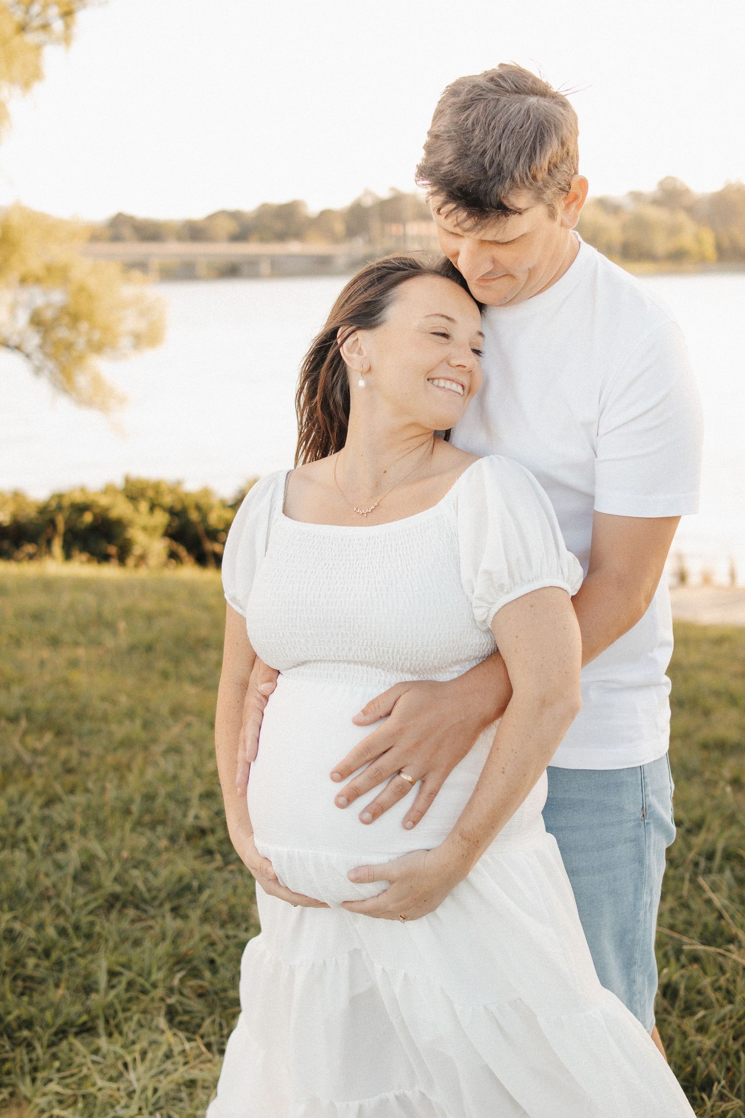 maternity photoshoot in Canberra at sunset with couple snuggling