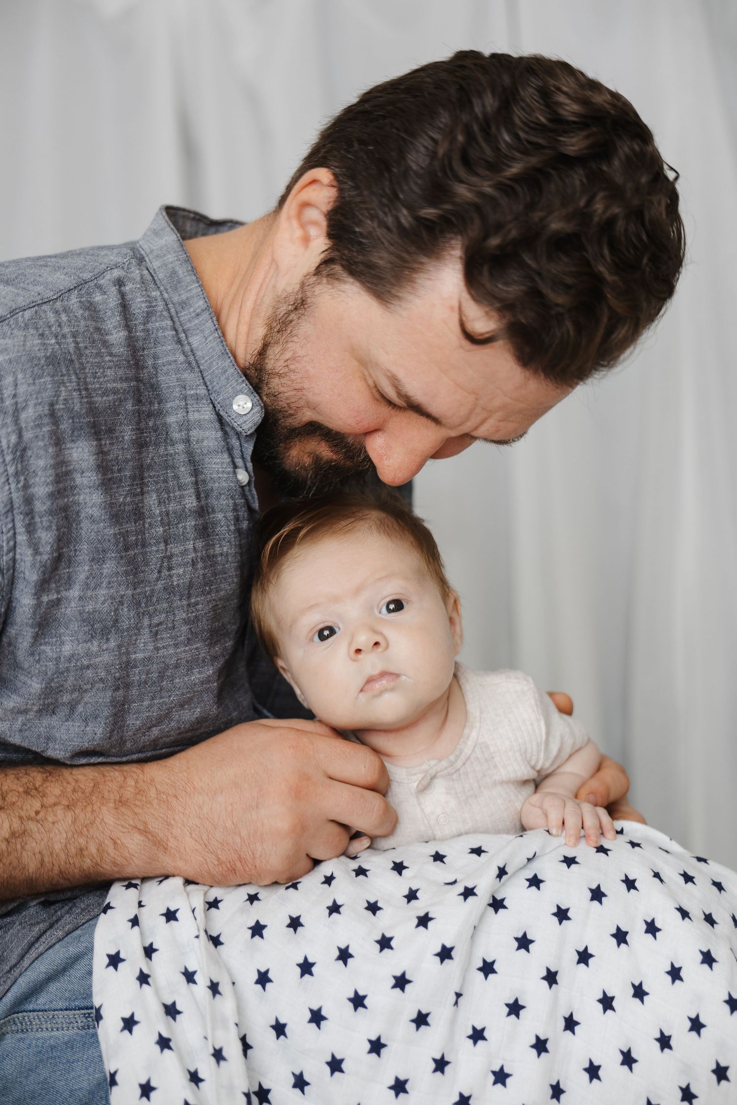 A newborn baby at a photoshoot in Canberra with his father