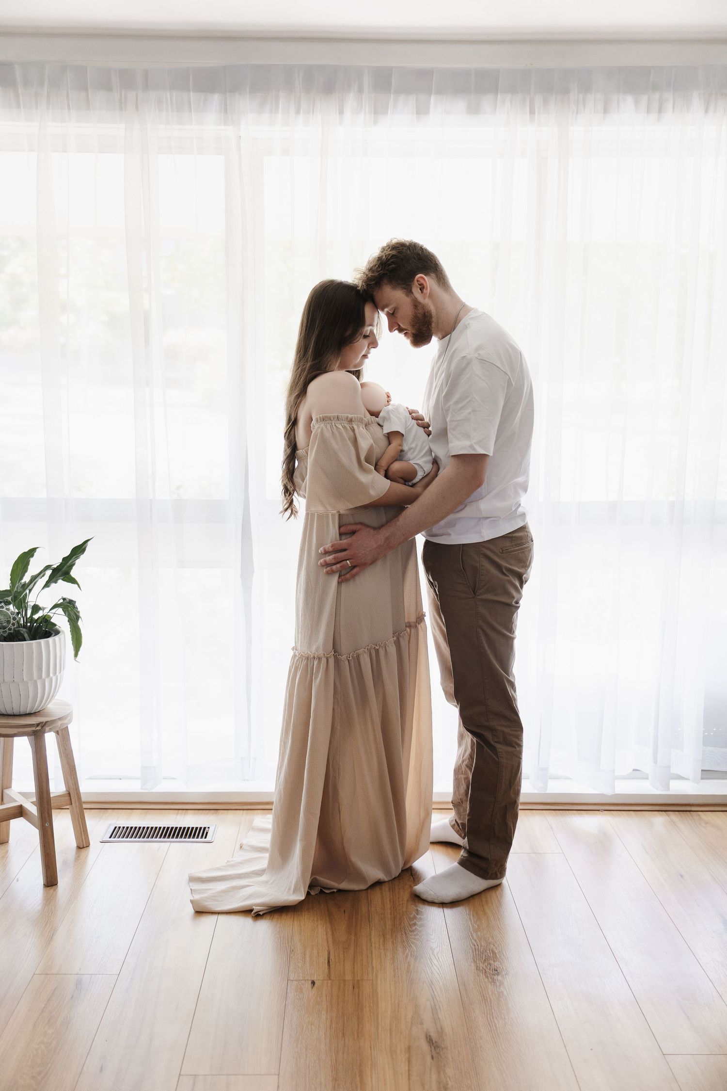 A couple holds their baby in Canberra newborn photoshoot