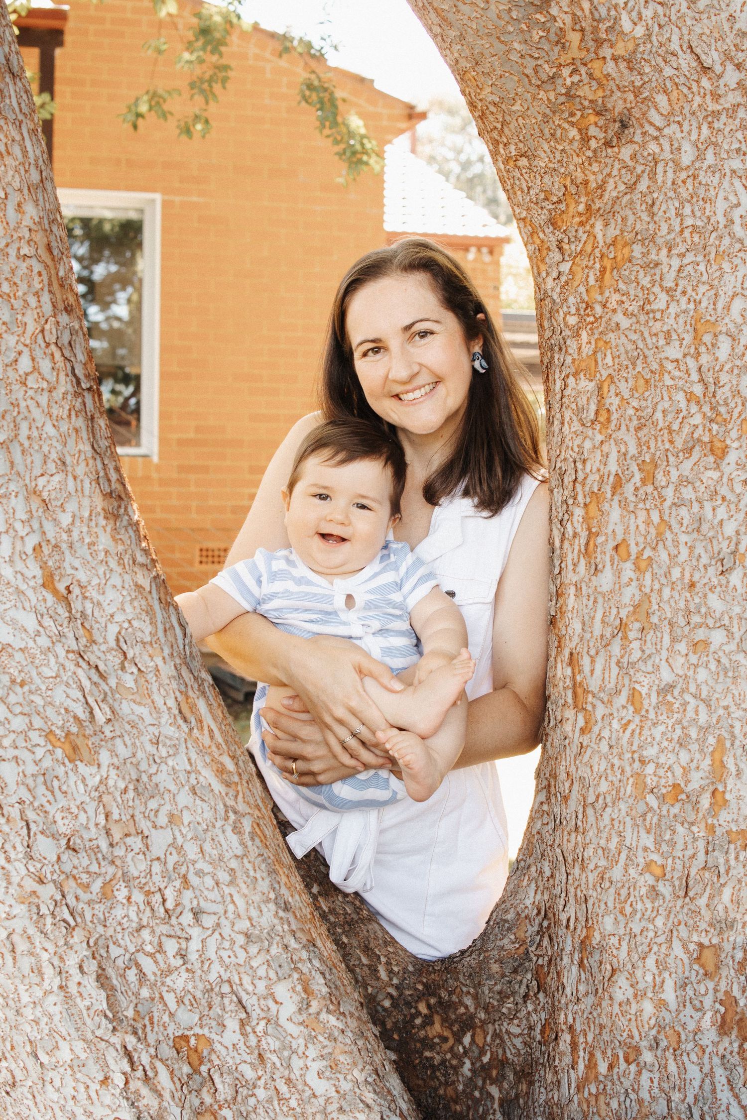 Mother and baby framed by a tree in Canberra family photographer shoot