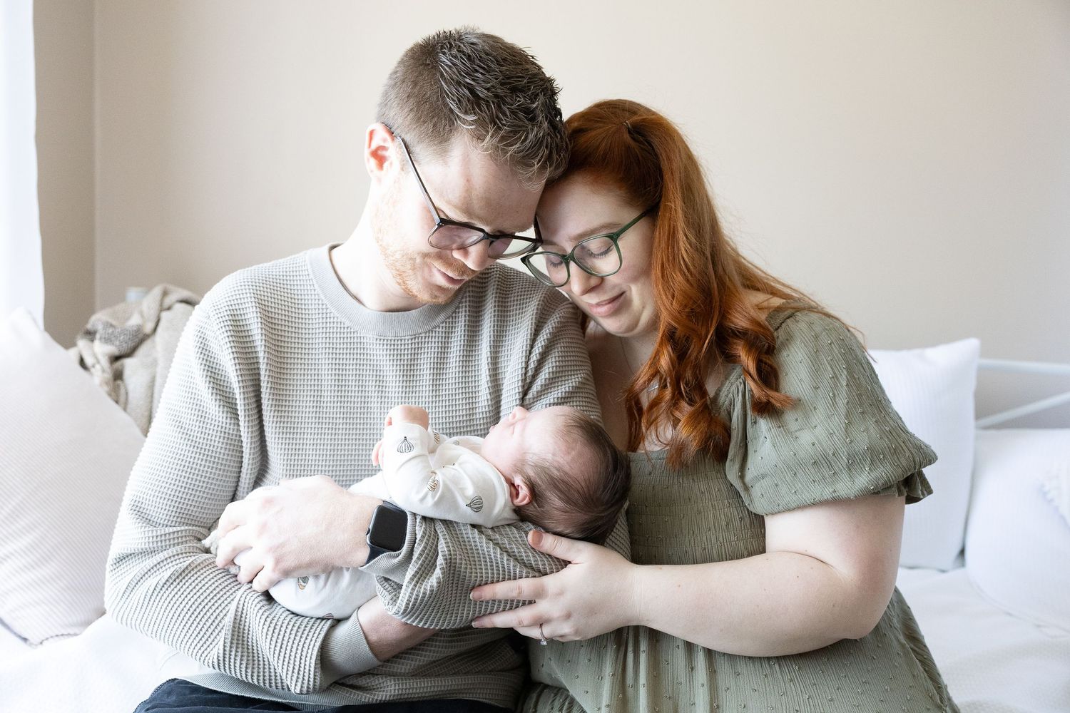 parents with newborn baby in photography studio belconnen canberra