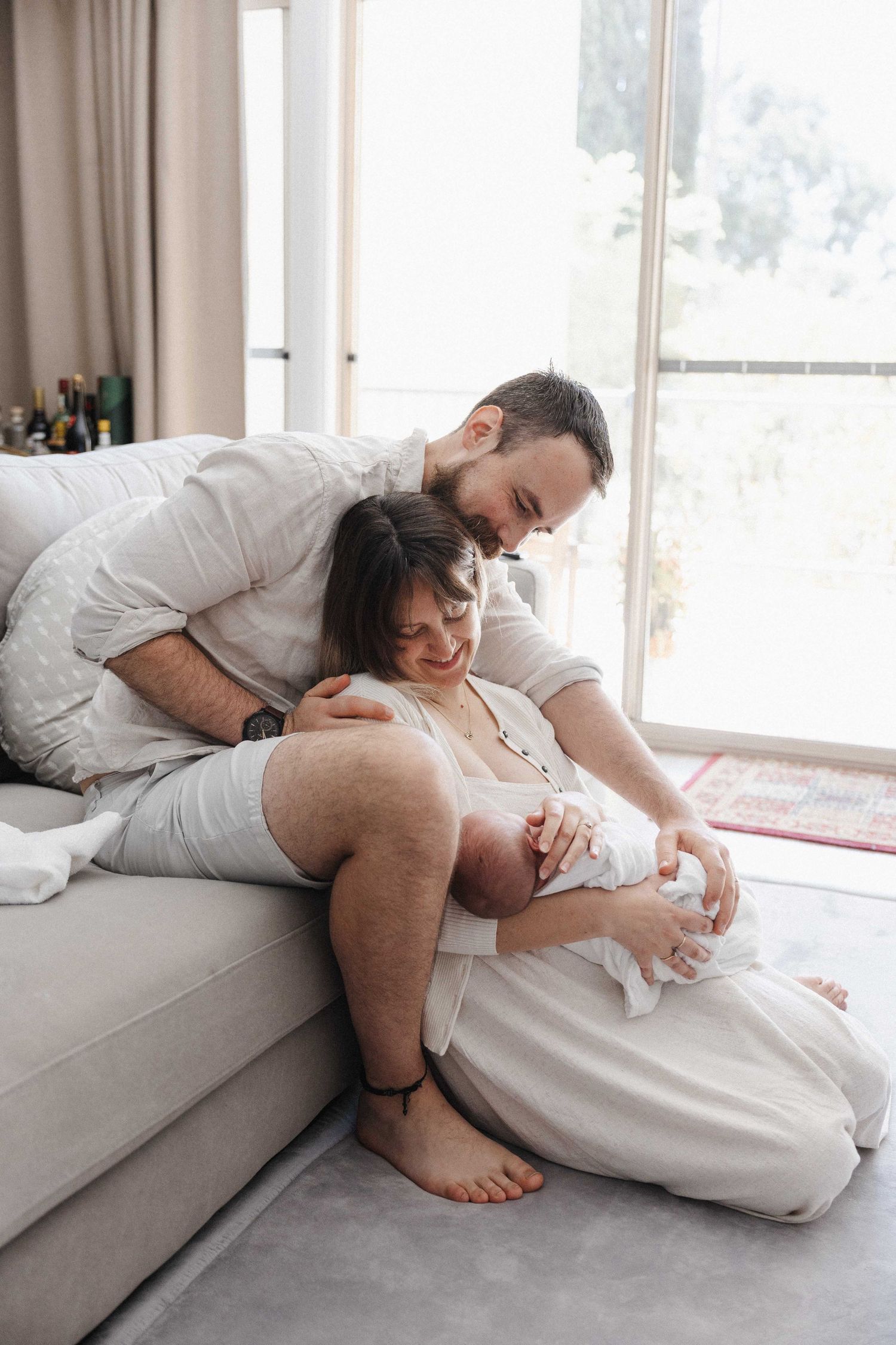 Parents dote on their newborn baby in their home photoshoot in Canberra