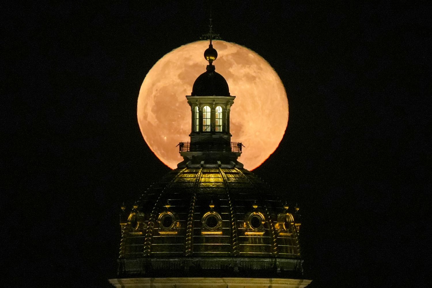 Buy a print of this photo of the full moon over the Iowa Capitol Building in the Buy Prints tab.