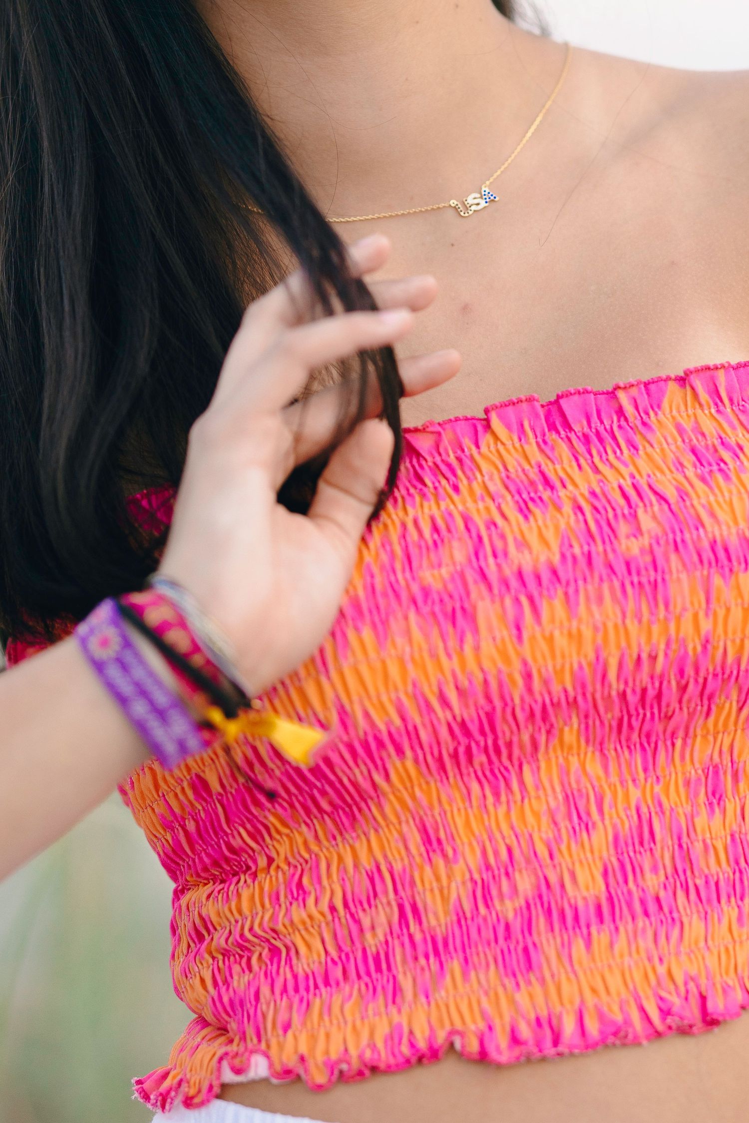 Close-up detail of vibrant pink and orange smocked fabric texture.