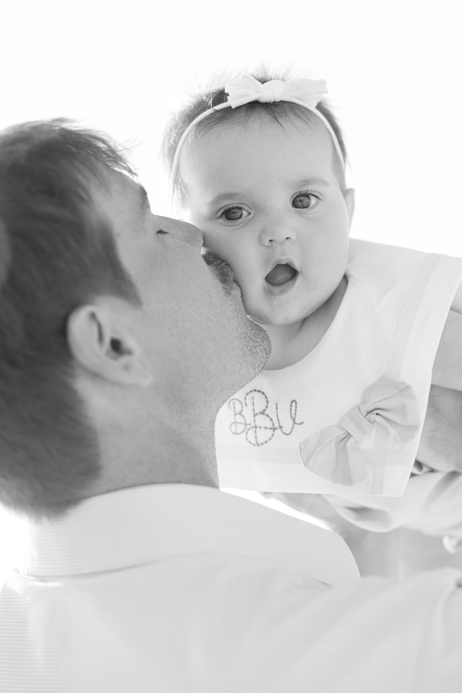Series of black and white artistic close-up photos showing intimate bonding moments between parent and baby.
