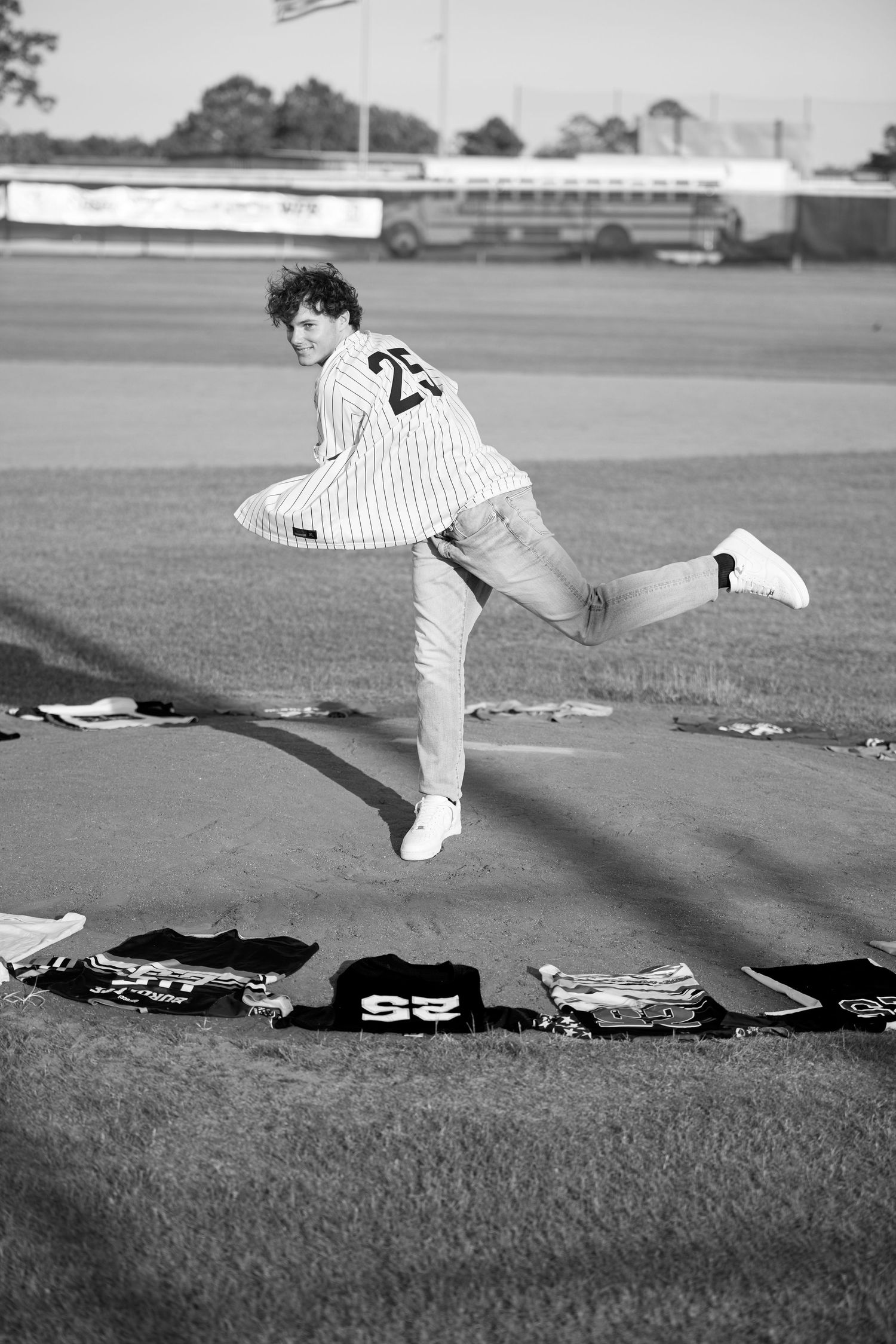 A sequence of black and white photos shows a baseball player diving and sliding across grass in a striped uniform.