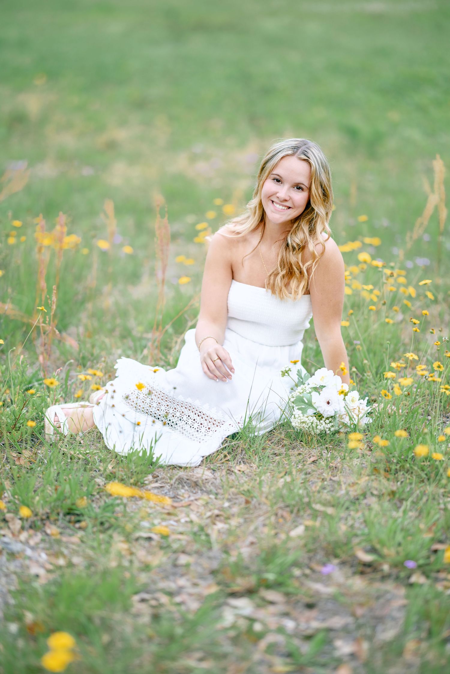 Natural light portrait in blooming wildflower field.
