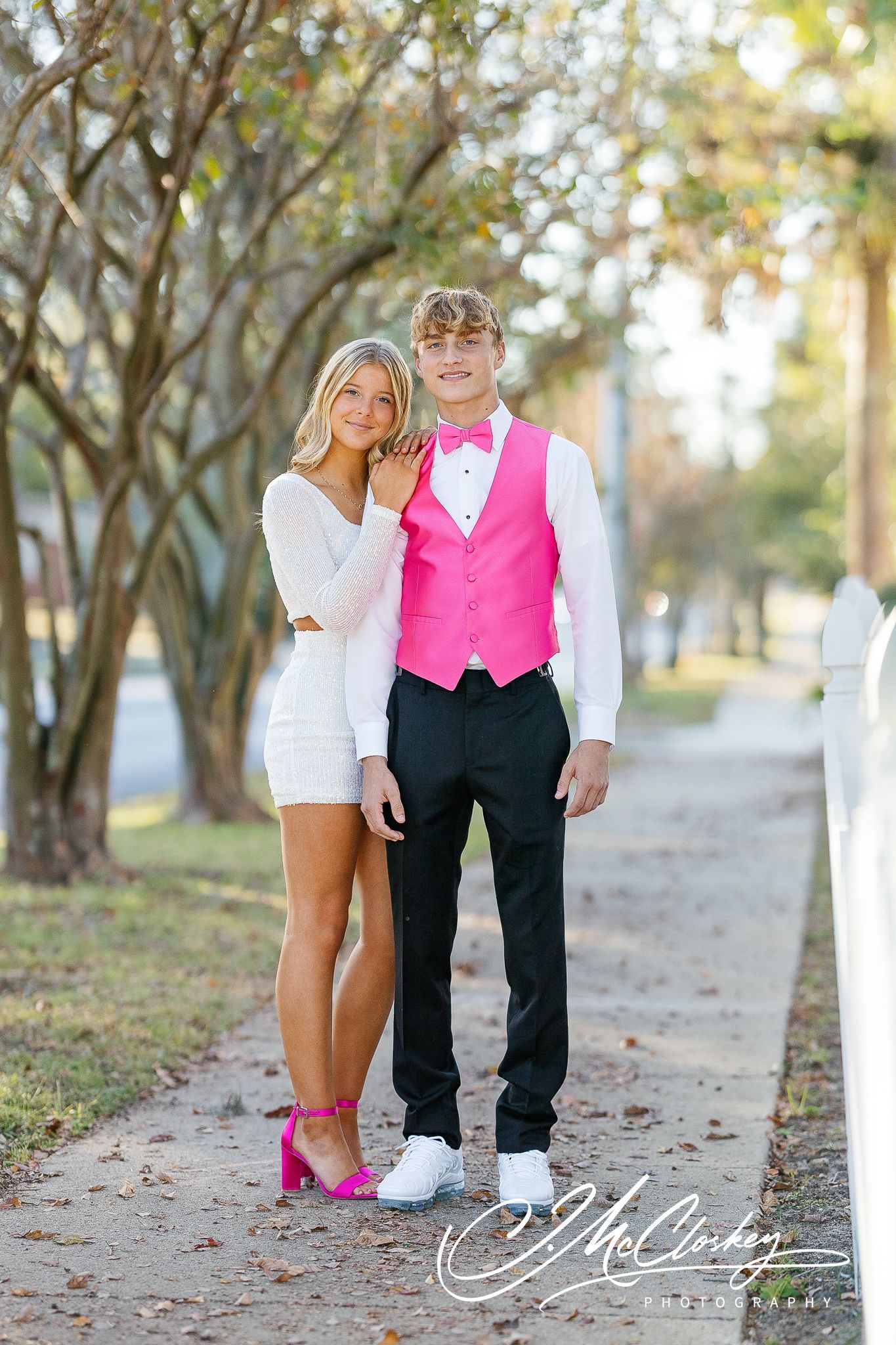 Three connected photos show couple's legs and feet on a fall path, with the figure wearing a bright pink vest.