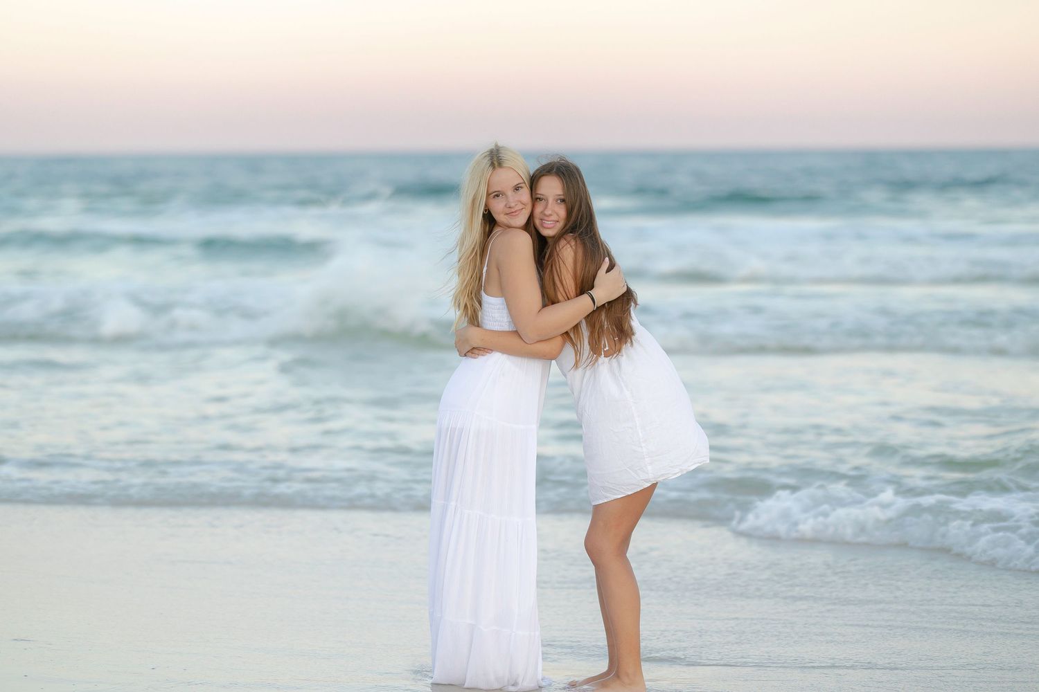 Beach photography session with friends enjoying sunset by the ocean.
