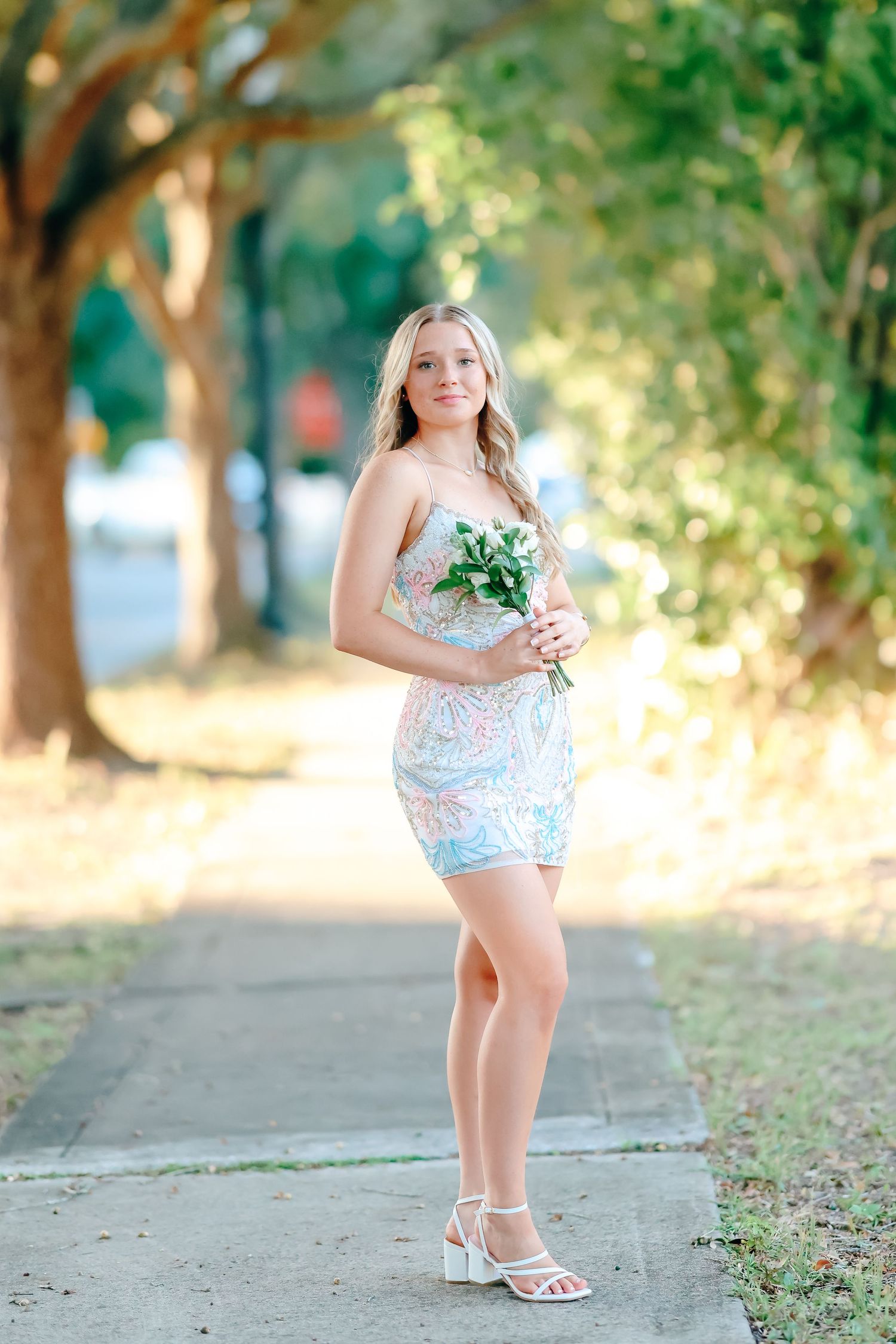 A series of outdoor portrait photos taken in a tree-lined path with soft natural lighting and green foliage.