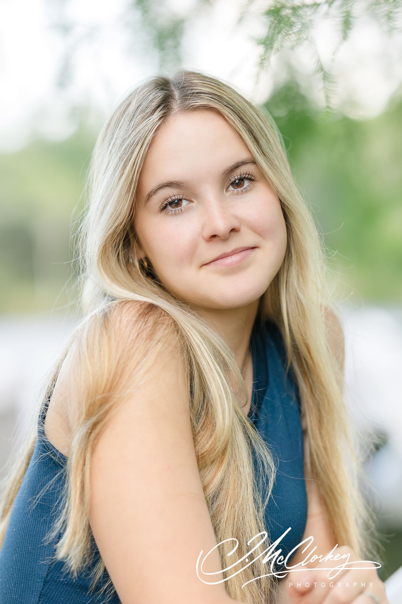 A set of four headshots captured in an outdoor setting with soft natural lighting and blurred greenery background.