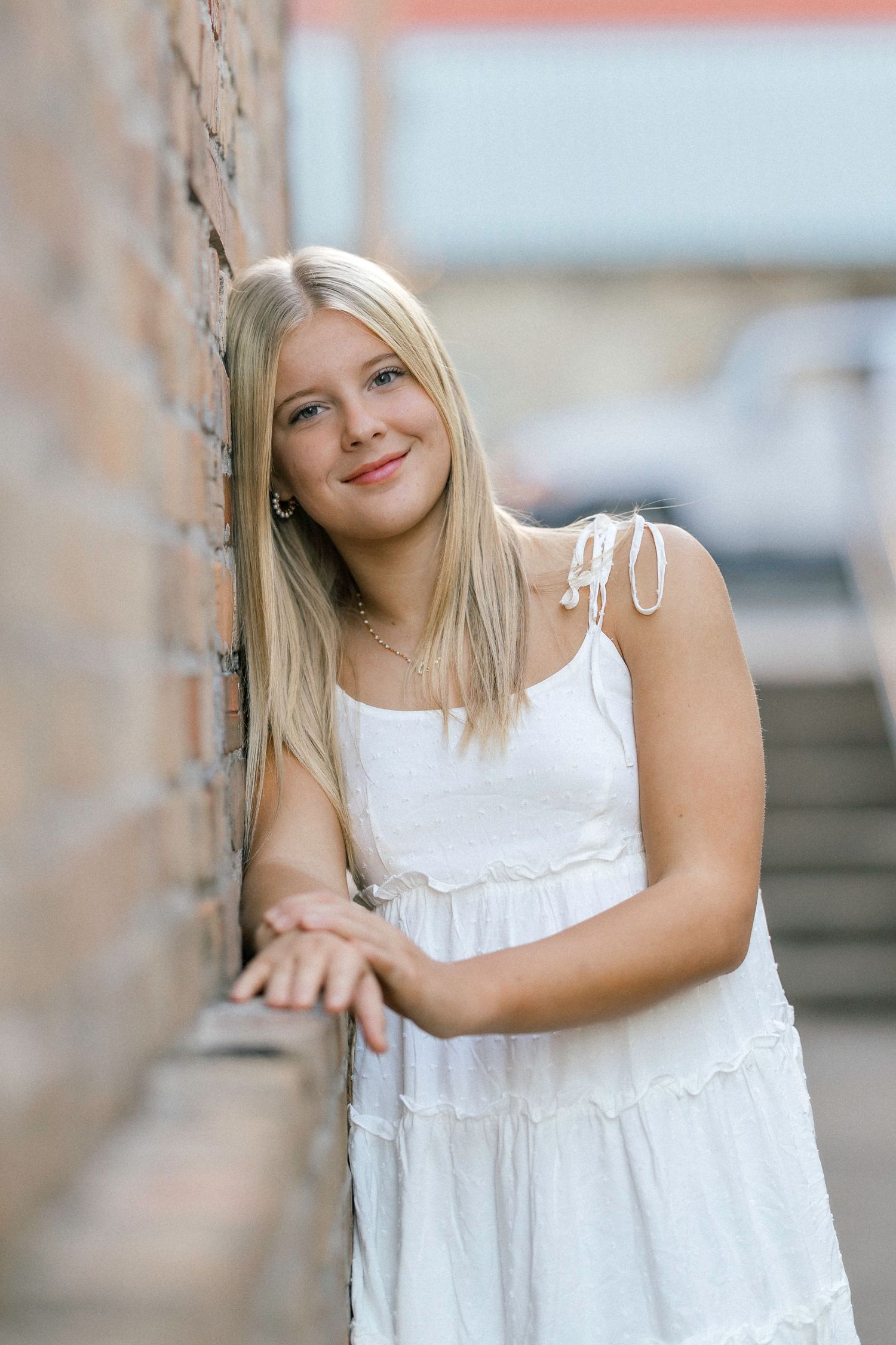 A series of photos showing someone in a flowing white summer dress posing against a soft blurred background.