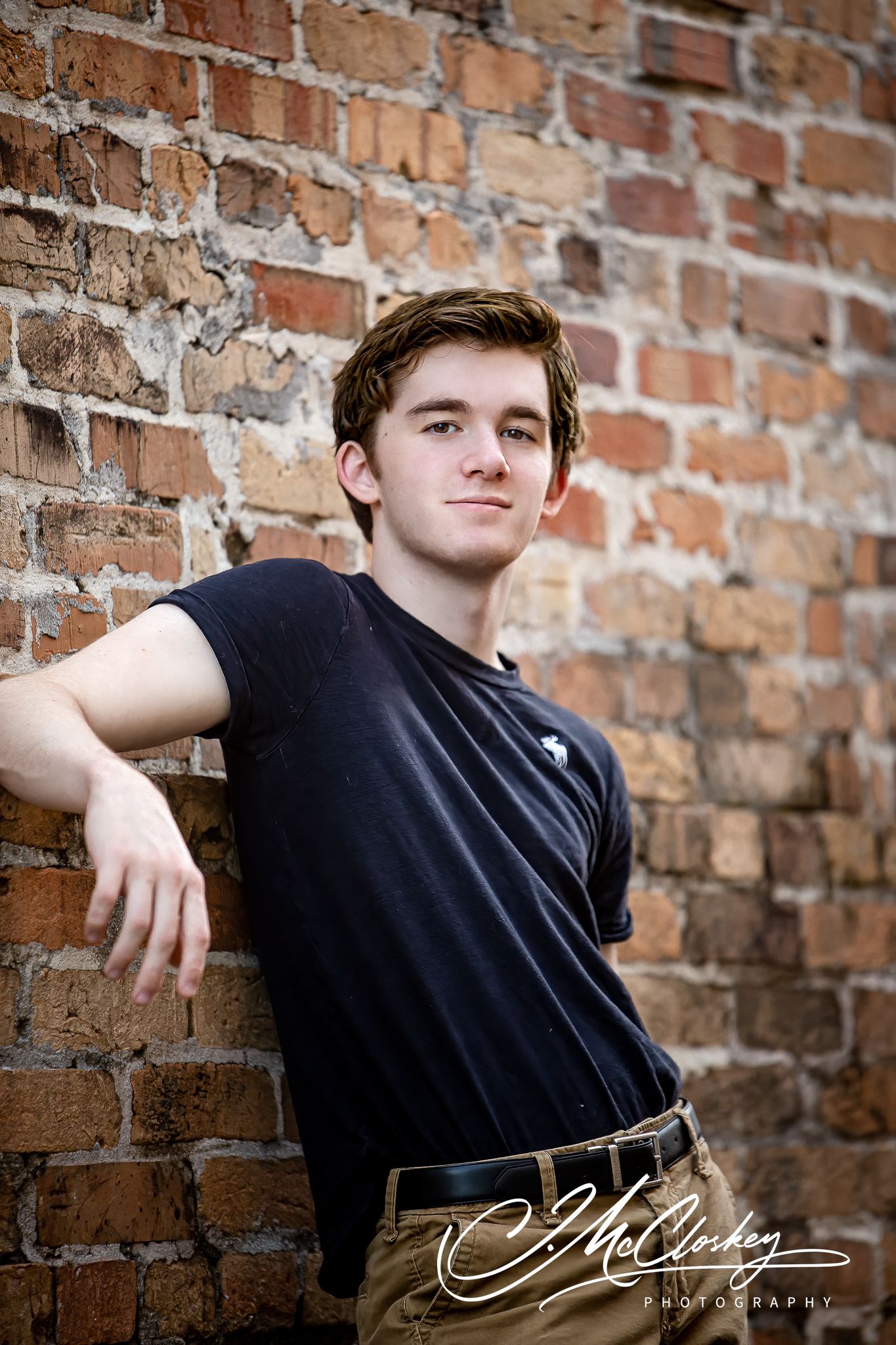 Artistic photo series showing a person in a black shirt leaning against a rustic brick wall.