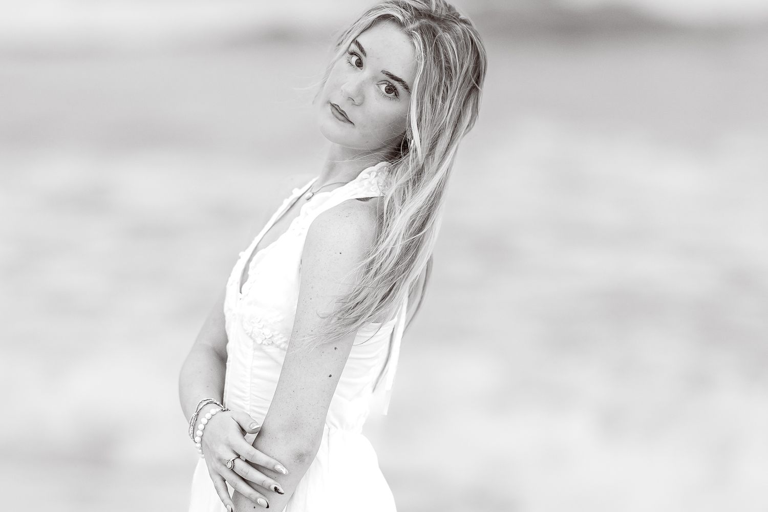 Black and white side profile portrait of person in white dress.