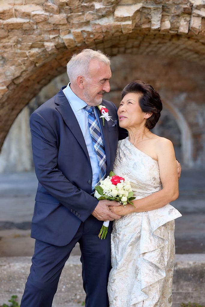 A romantic wedding photo sequence showing a couple embracing under stone archways.