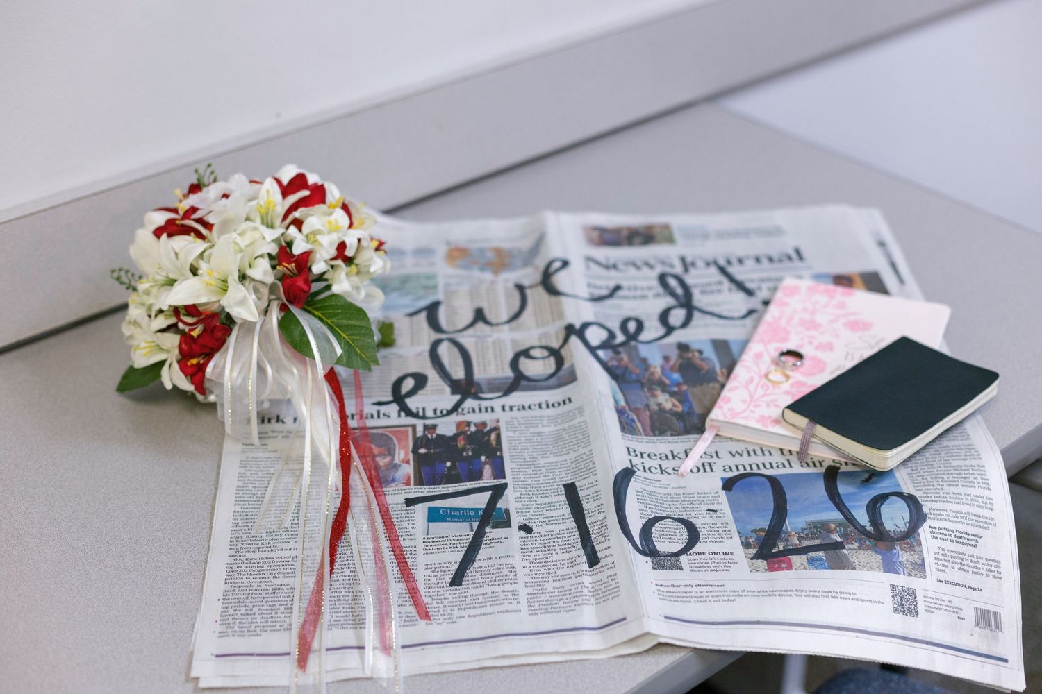 Wedding bouquet with red and white flowers on a newspaper with 