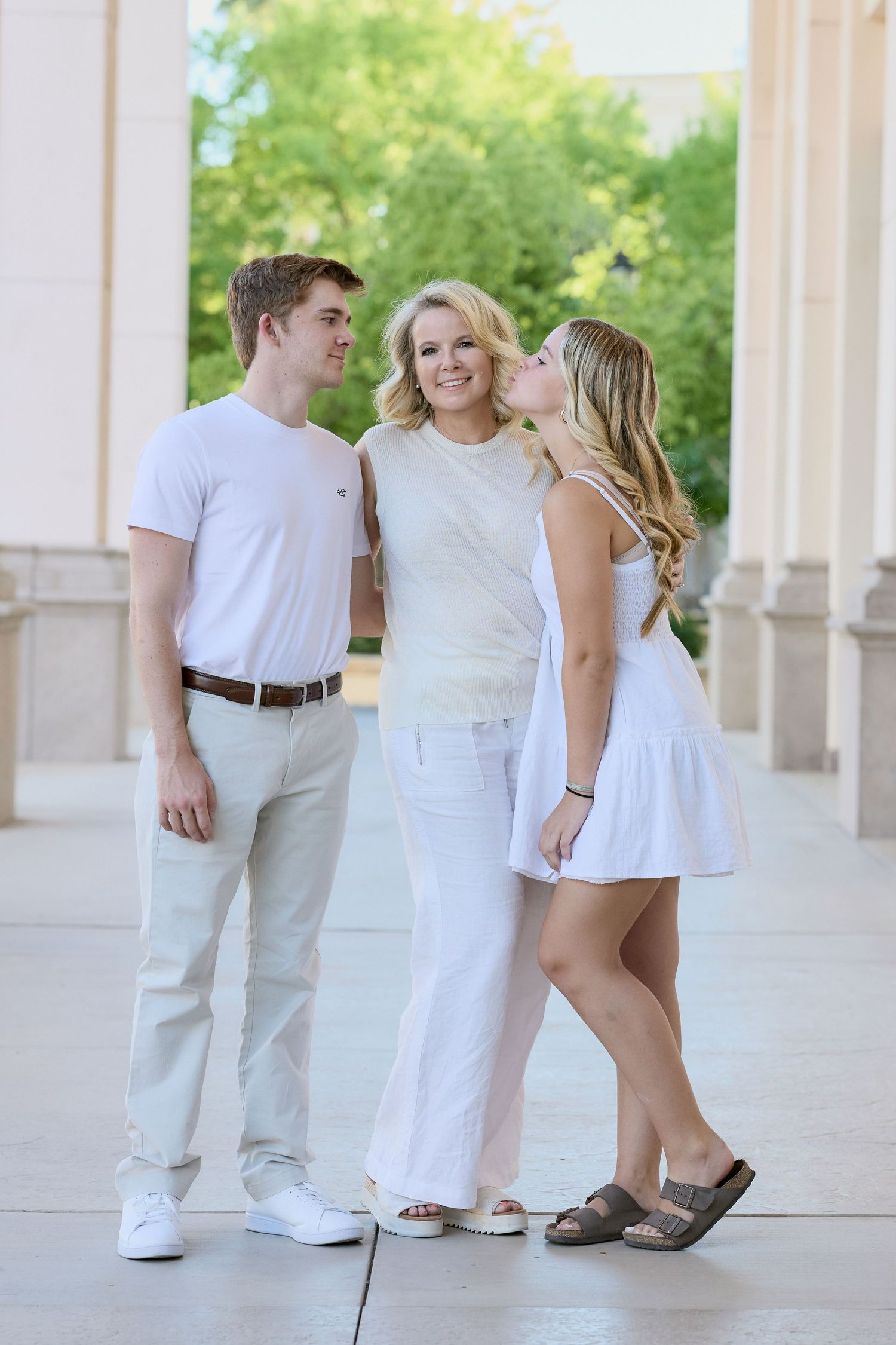 Three connected images showing people in white clothing with their feet in casual poses against columns in an outdoor setting.