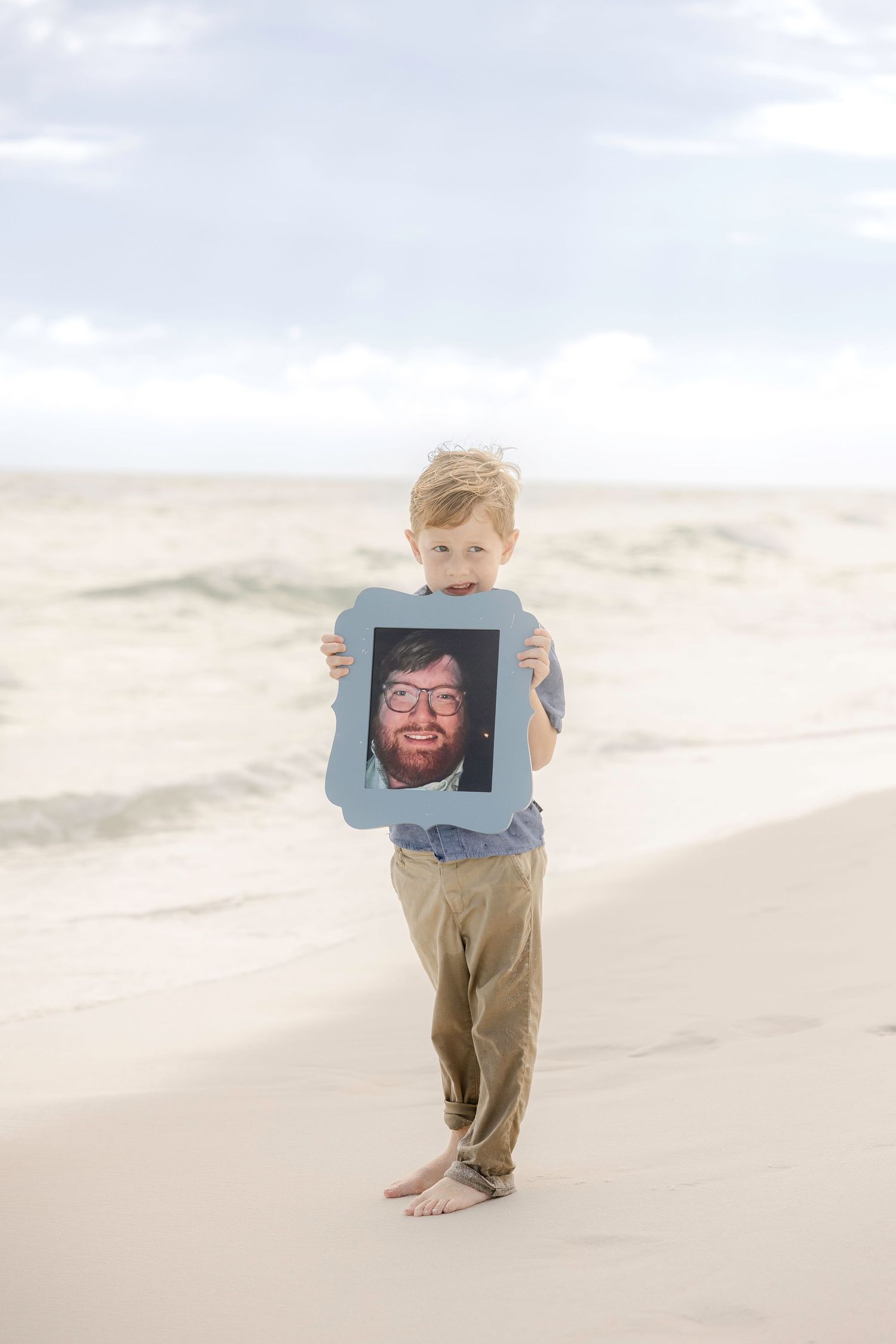 A sequence of photos showing a person holding a blue frame on a sandy beach.