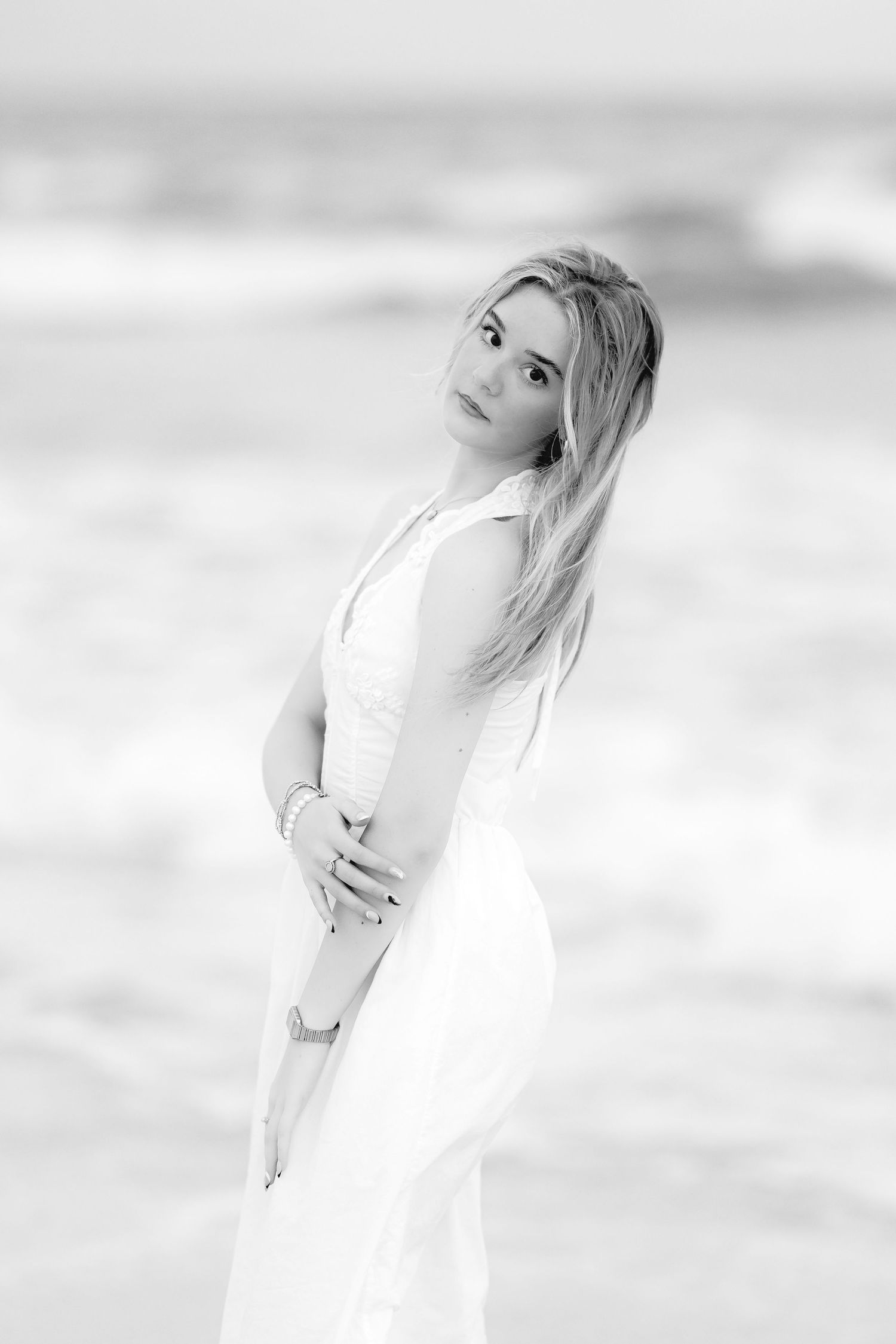 A dreamy black and white portrait series showing a woman in white clothing against a soft ethereal background.