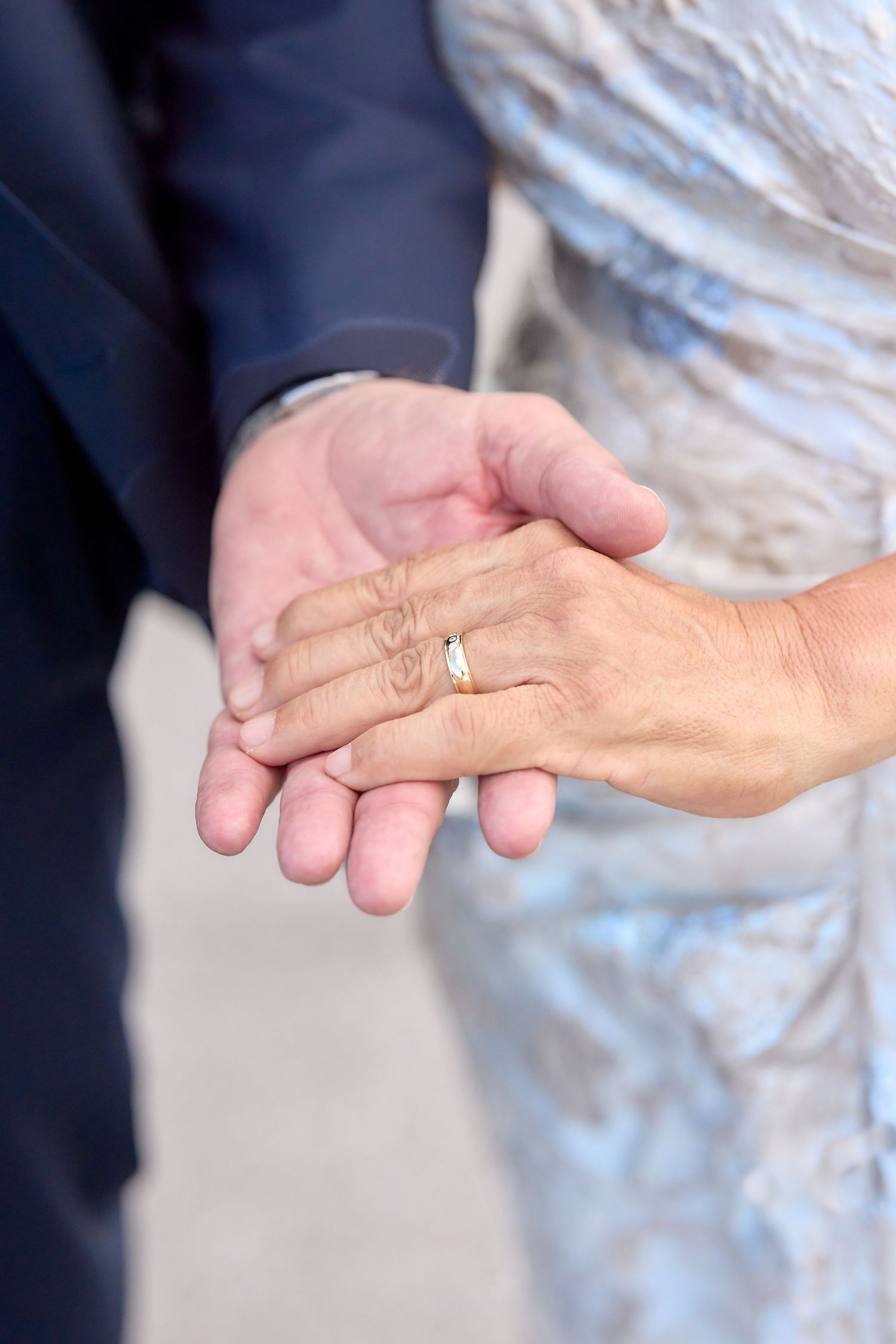 Close-up series of hands in motion demonstrating sign language gestures against a light background.