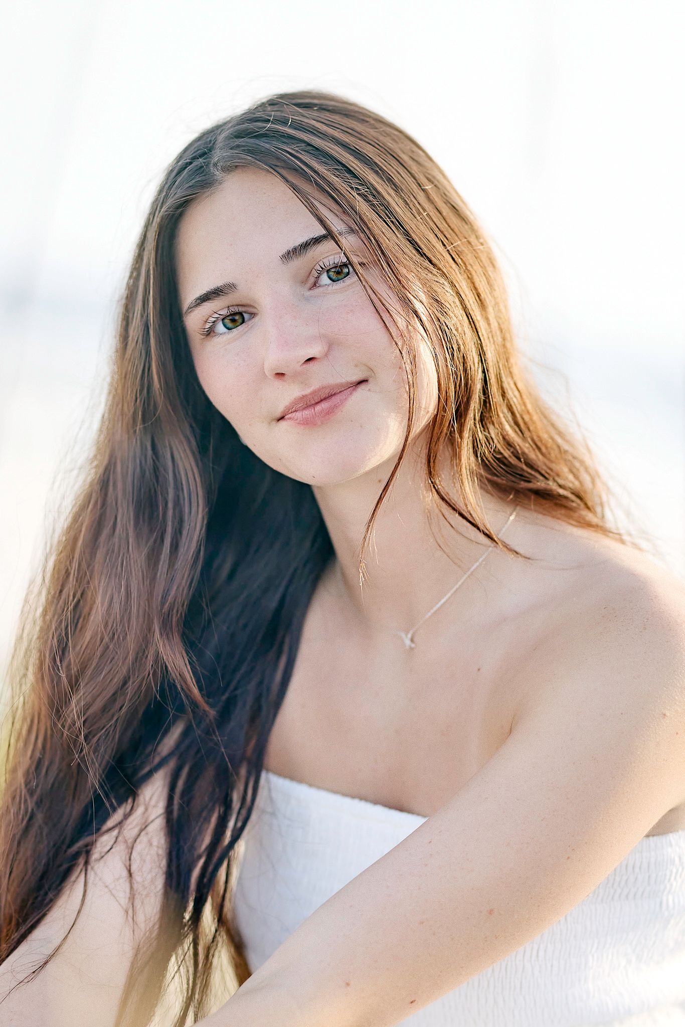 Dreamy close-up portraits with soft lighting showing someone wearing a white top against a bright background.