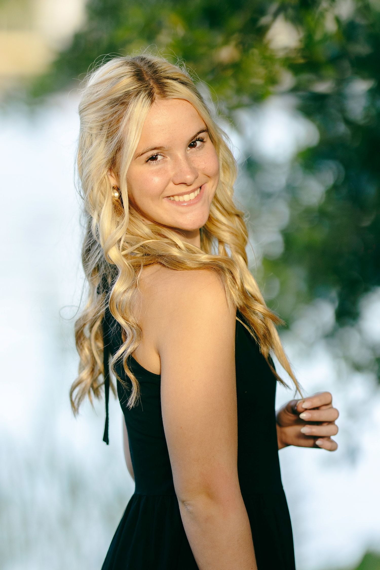 Four similar outdoor portrait shots showing a person in a black sleeveless top against a soft blurred natural background.