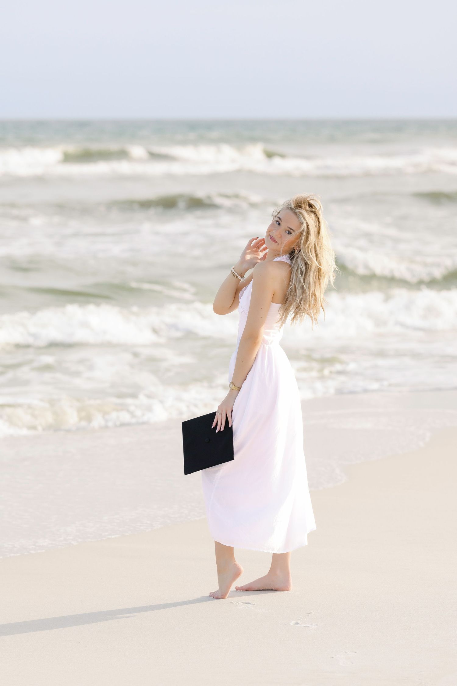 Ethereal beach photography sequence with flowing pink dress against ocean waves.