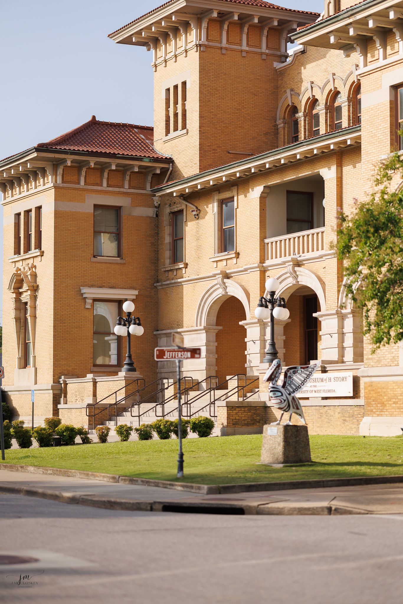 Historic Italian Renaissance style courthouse building with tan brick facade and ornate architectural details in Victoria, Texas.