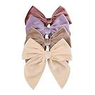 Assorted hair bows in pink, purple and neutral colors arranged in a line.