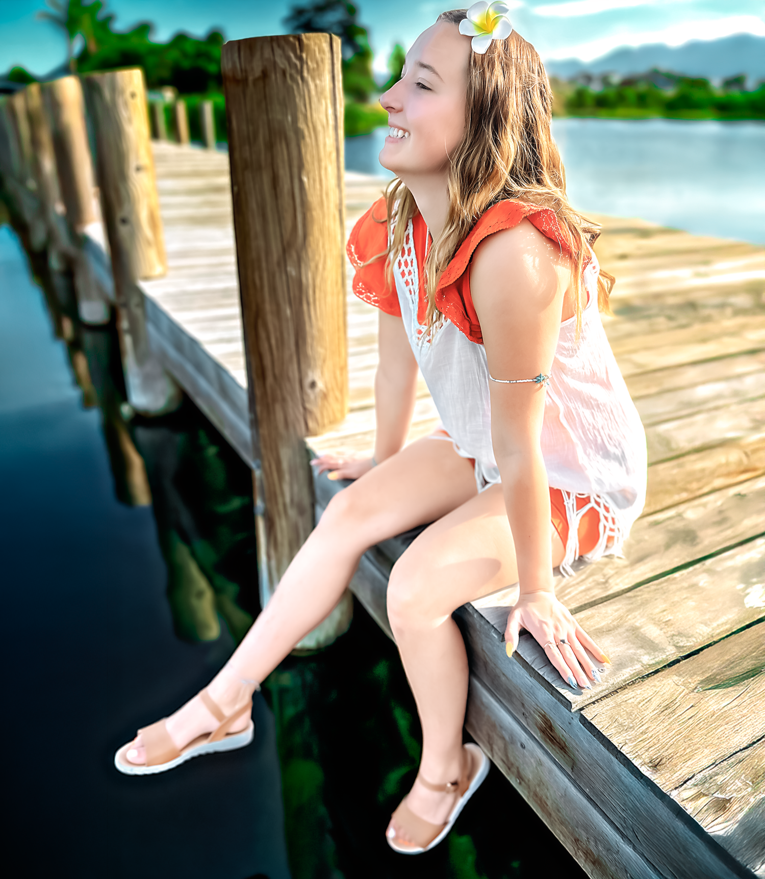 Summer portrait on lakeside dock with mountains in background.