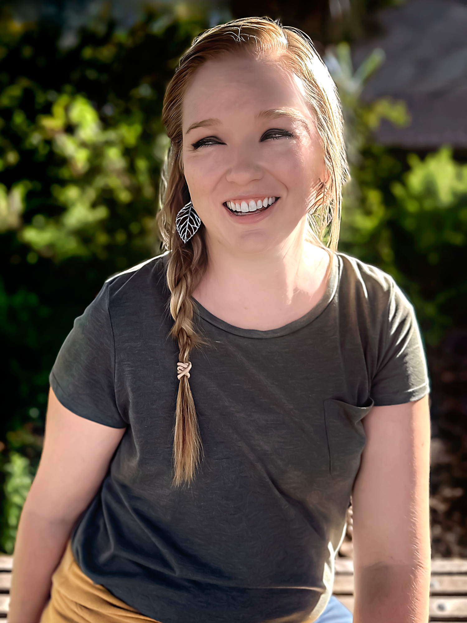 Casual portrait series showing genuine laughter in outdoor setting.