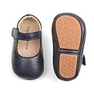 Collection of leather baby shoes and sandals in neutral colors.