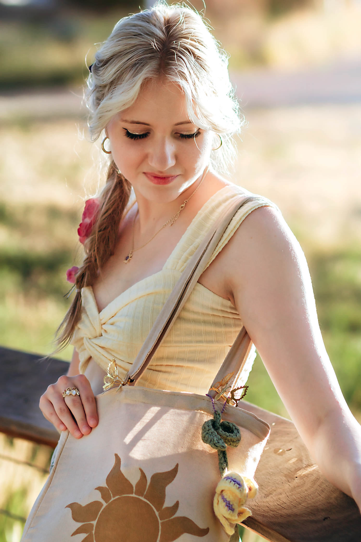 Close-up shots of a cream colored dress with delicate details in natural sunlight.