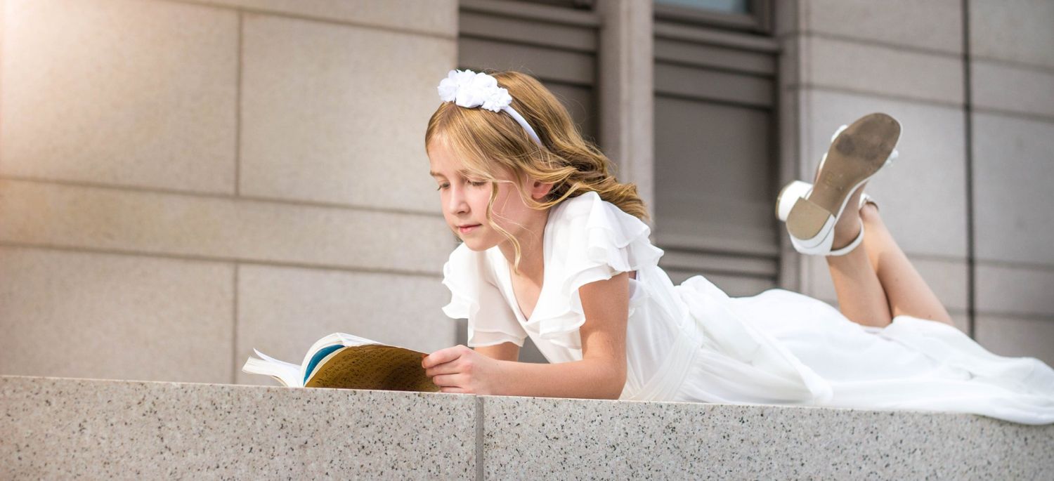 White dress photographed against stone building architecture.