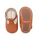 Brown leather soles and bottoms of children's shoes arranged in a line.