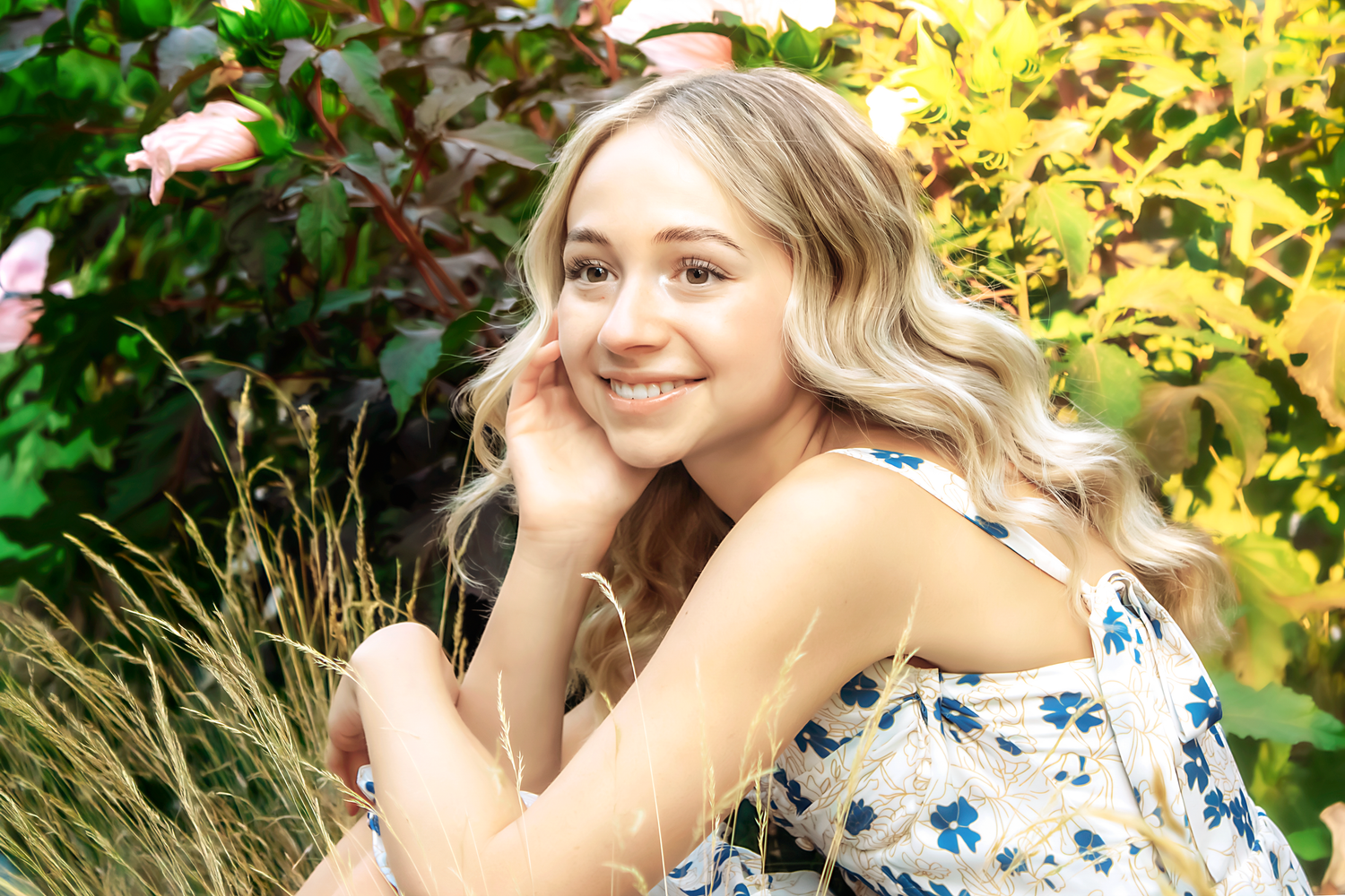 Candid summer portraits featuring a blue and white floral dress in golden sunlight.