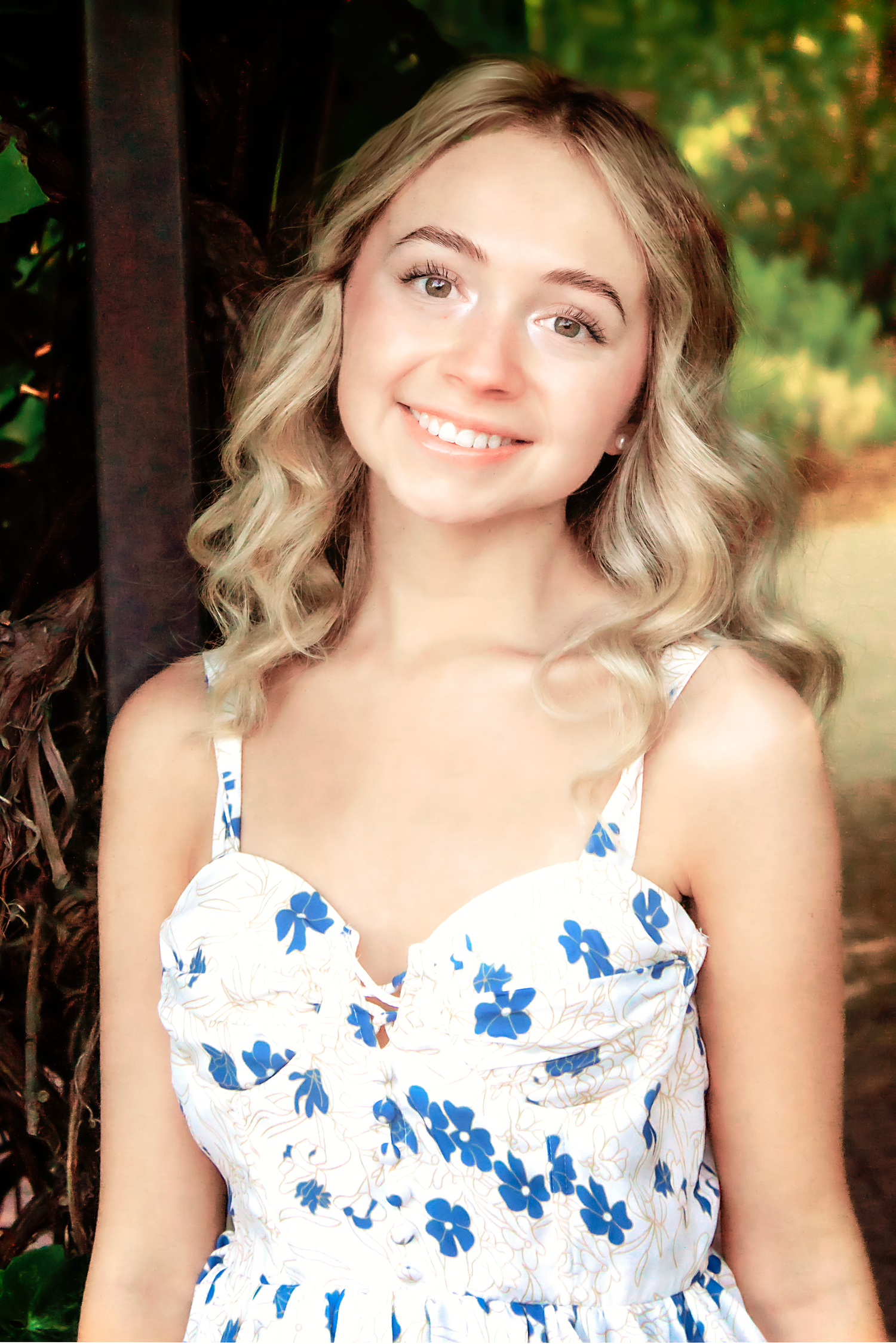 White and blue floral sundress captured in a series of outdoor portrait shots with natural lighting.