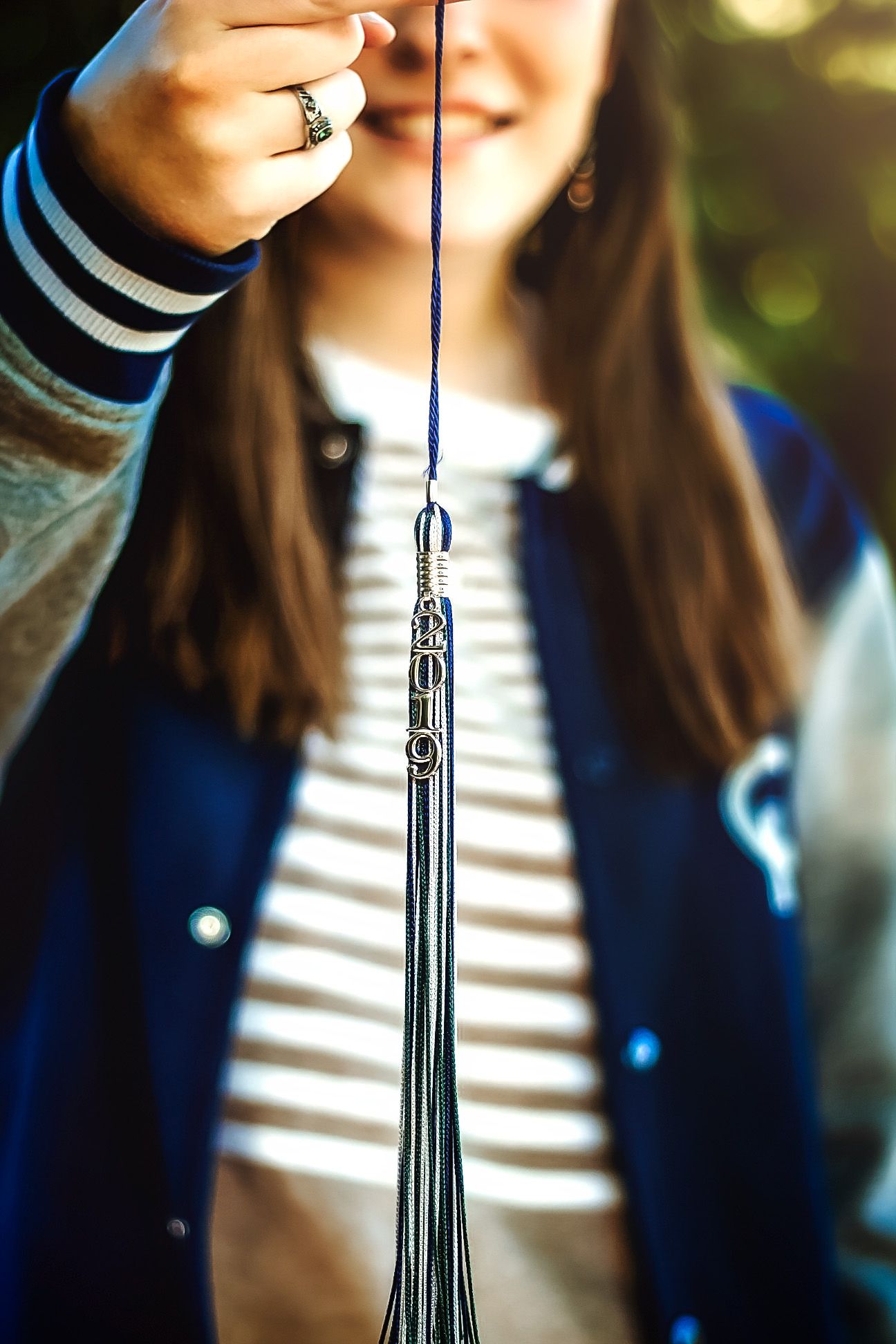 Close-up shots of a graduation tassel with blue and silver details.