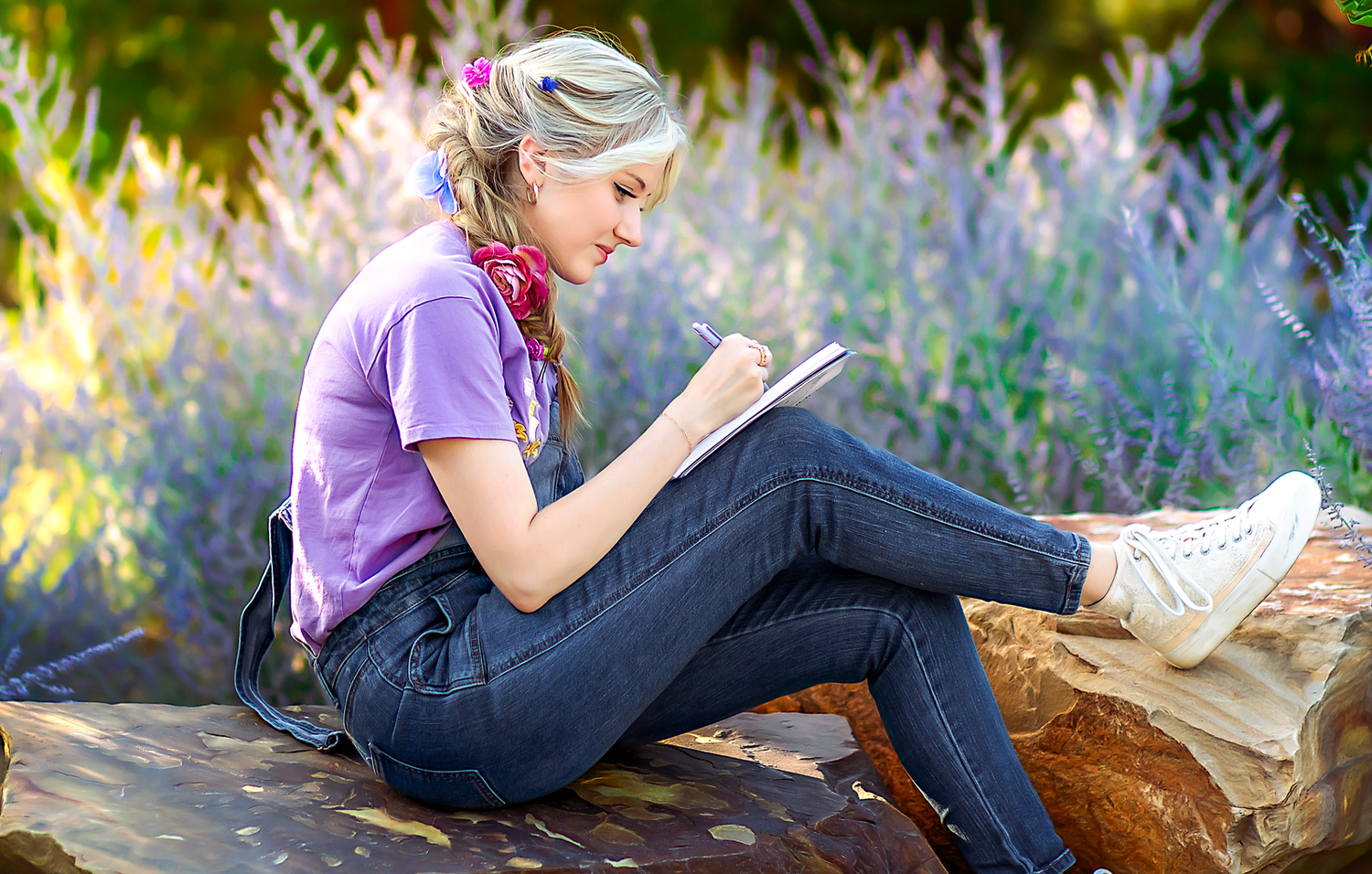 Artistic portrait series showing relaxed poses among purple wildflowers.