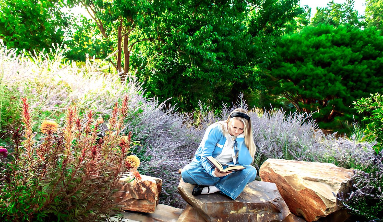 Garden photography session with natural greenery and stone wall backdrop.