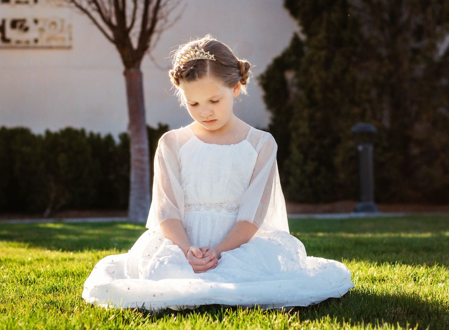 Series of shots showing someone in white dress sitting on sunny grass.