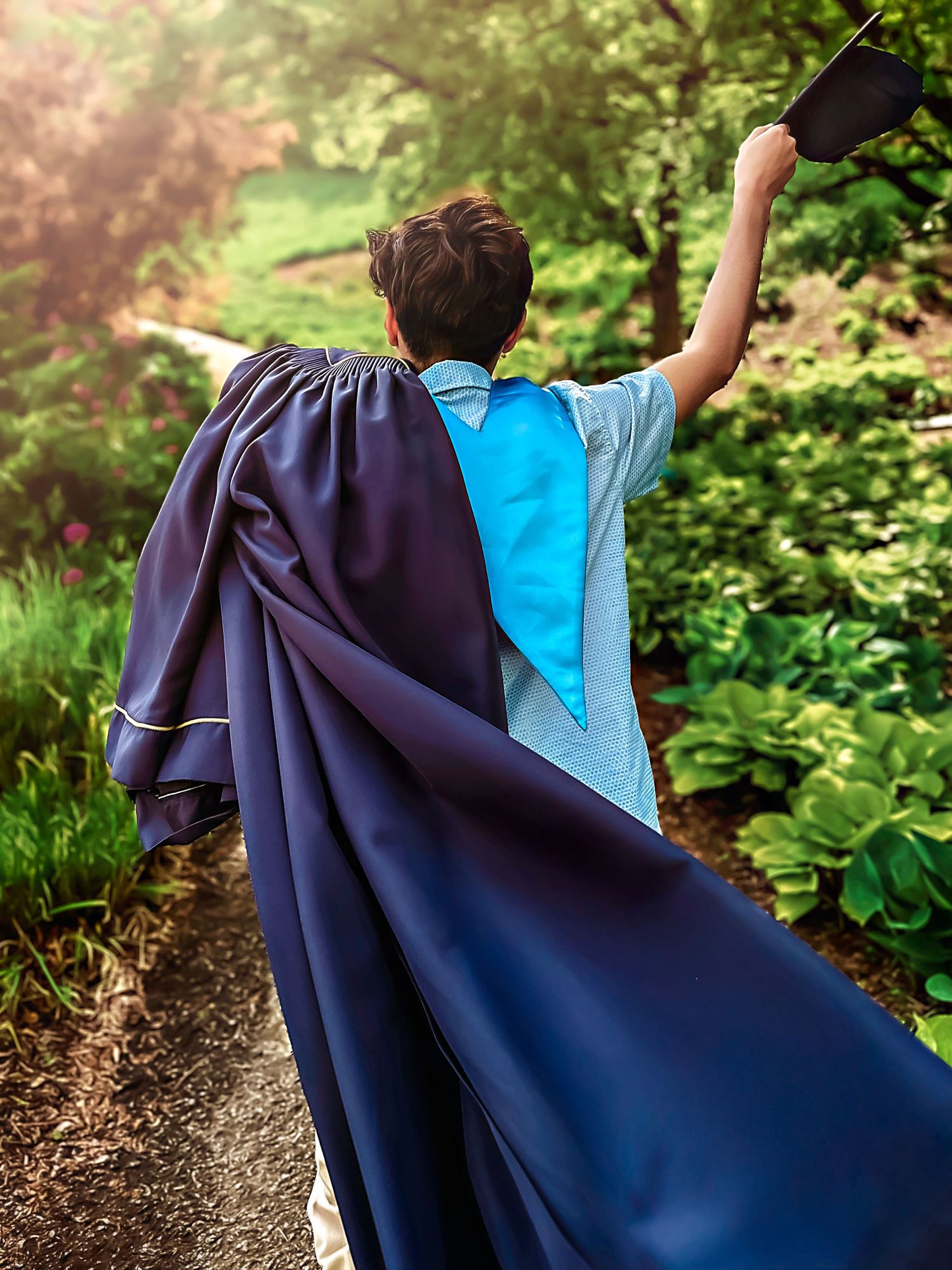 Series of photos showing navy blue graduation gown flowing in garden setting.