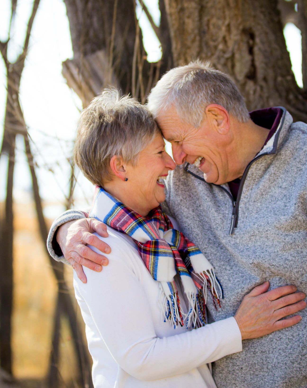 Couple in casual winter attire share intimate moments during an outdoor photo session.