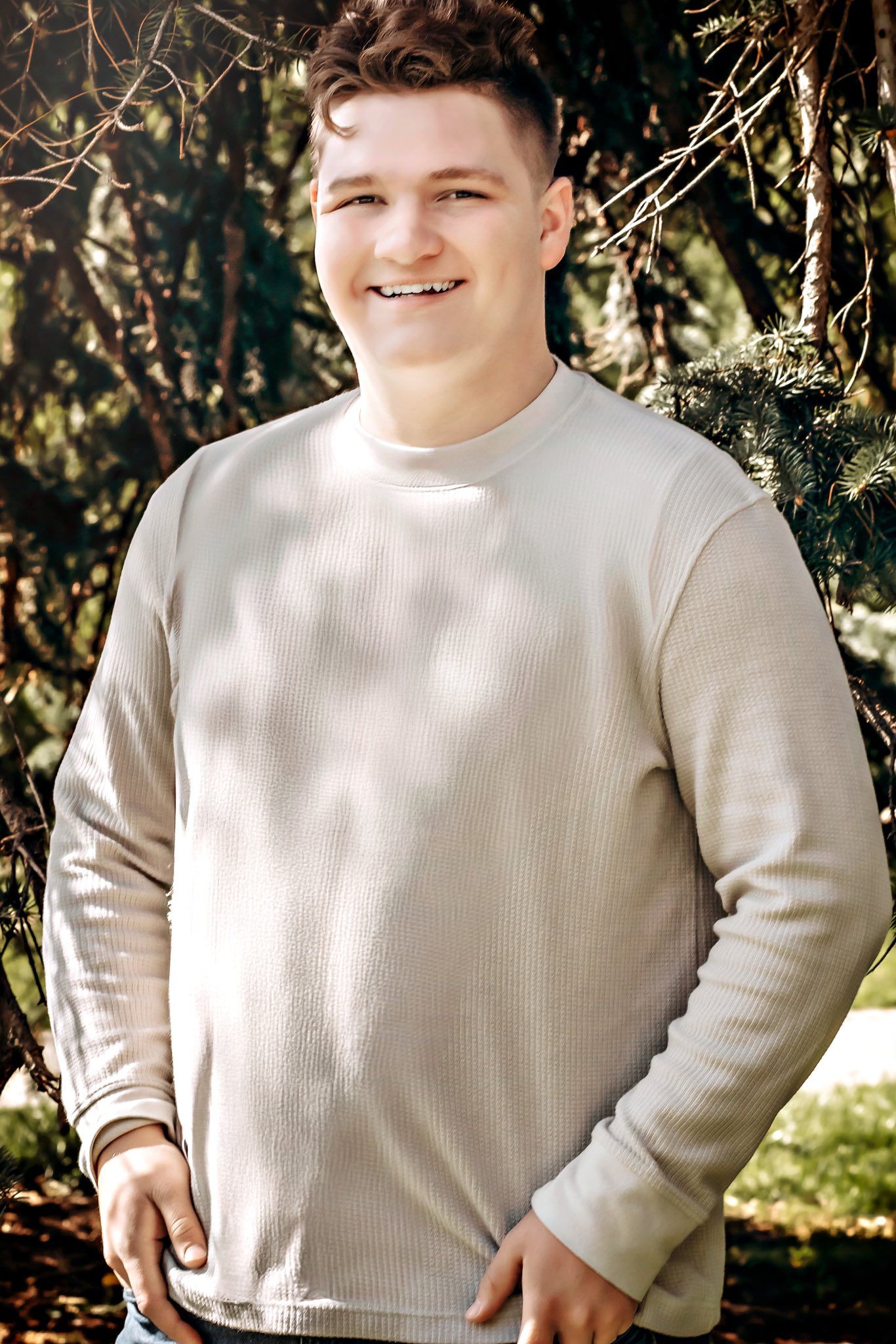 A series of casual portraits in a cream colored sweater with natural lighting and trees in background.