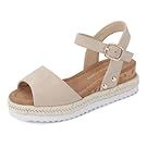 Beige platform sandals with crossover straps and buckle closure.