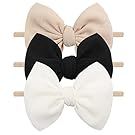 Assorted beige and white hair bows and accessories arranged in a row.